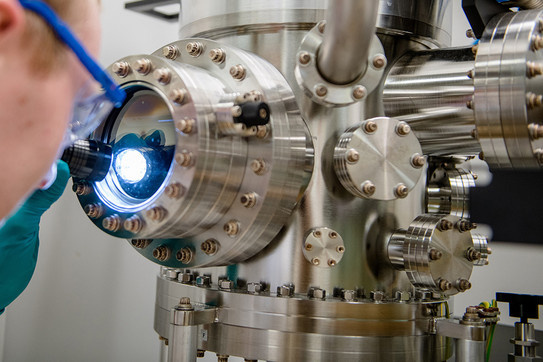 Cutaway of a person shining a flashlight into the opening of a laboratory apparatus