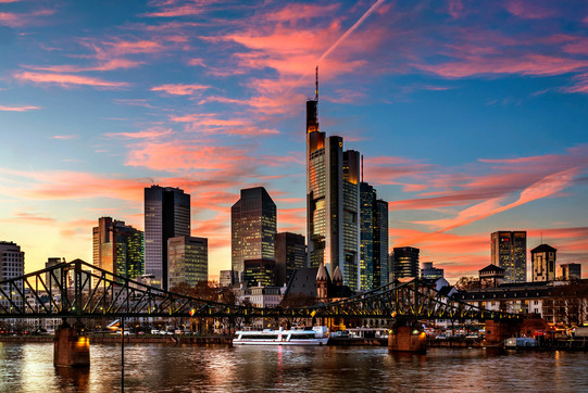 Skyline of Frankfurt am Main, in the foreground the Main river with a bridge, dusk