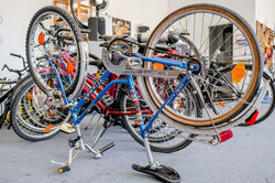 Bike repair shop An upturned bicycle being repaired. More bikes can be seen in the background.