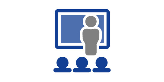 Simplified drawing of a person standing in front of a screen and speaking to people in the audience